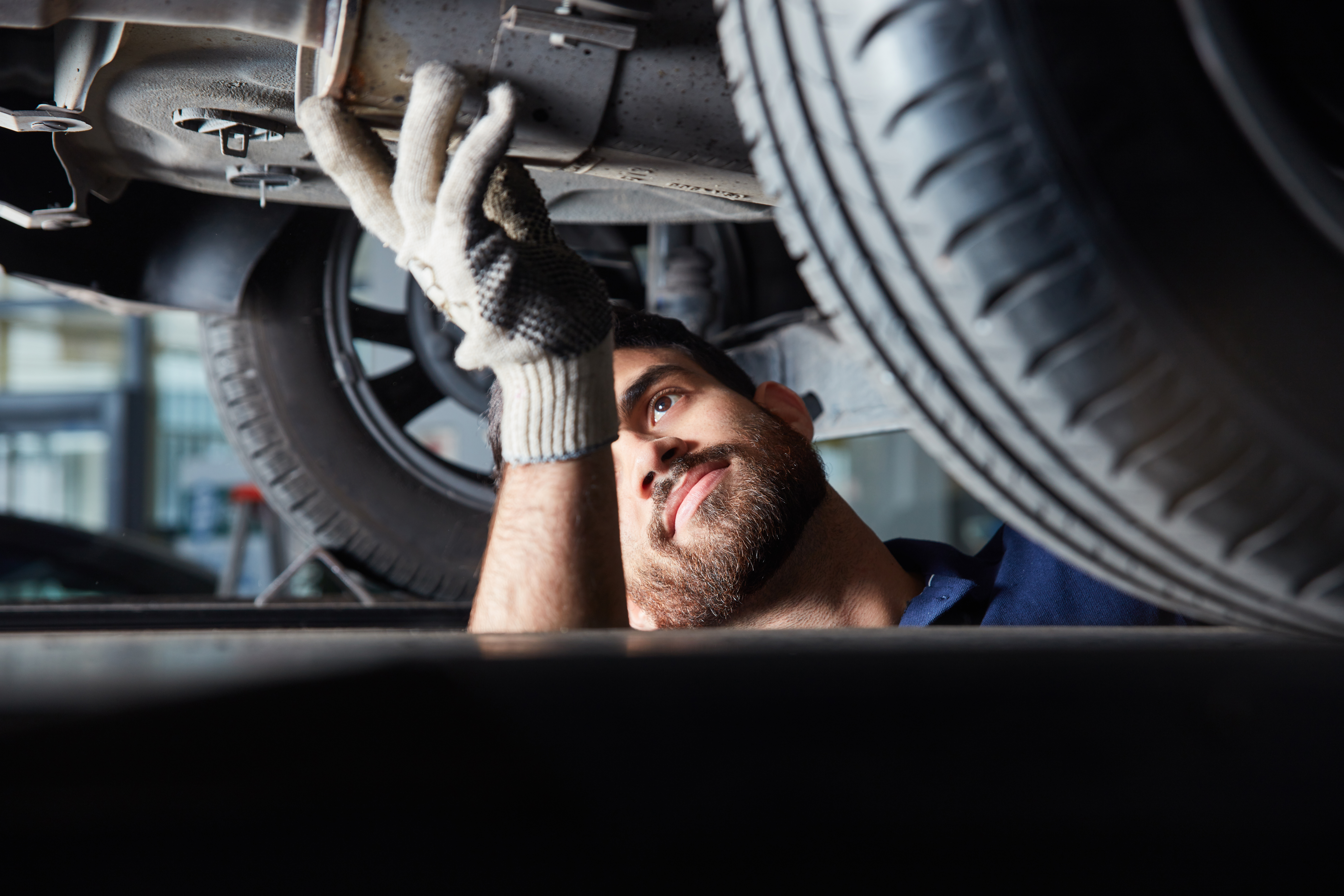 Mechatroniker bei der Reparatur von Auto Auspuff